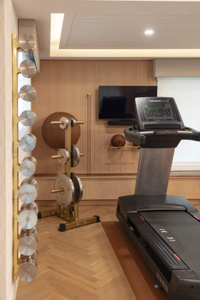 Exercise home gym with beautiful herringbone pattern White Oak hardwood flooring