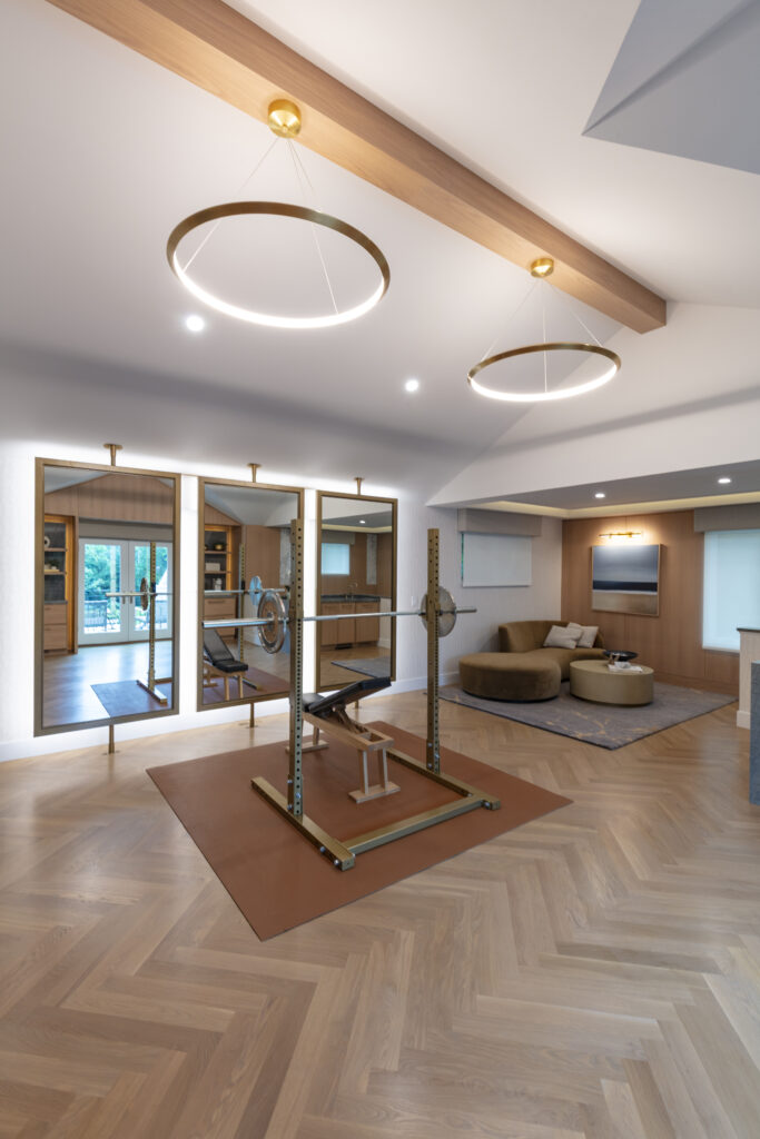Exercise home gym with beautiful herringbone pattern White Oak hardwood flooring